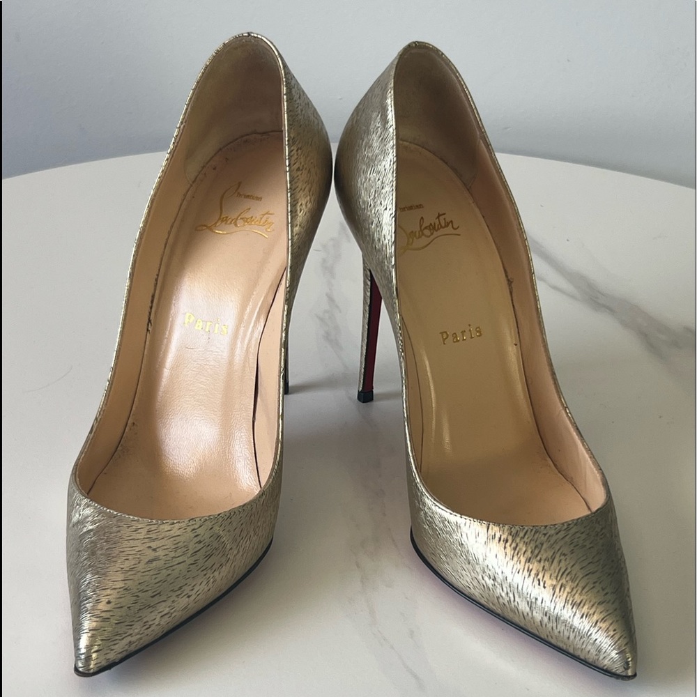 Christian Louboutin gold pumps